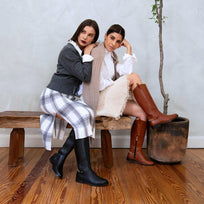 Dos modelos en interior luciendo botas altas negras y cafés de Regina Romero en combinaciones casuales