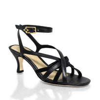 Vista en ángulo de las sandalias negras con tiras cruzadas y tacón medio